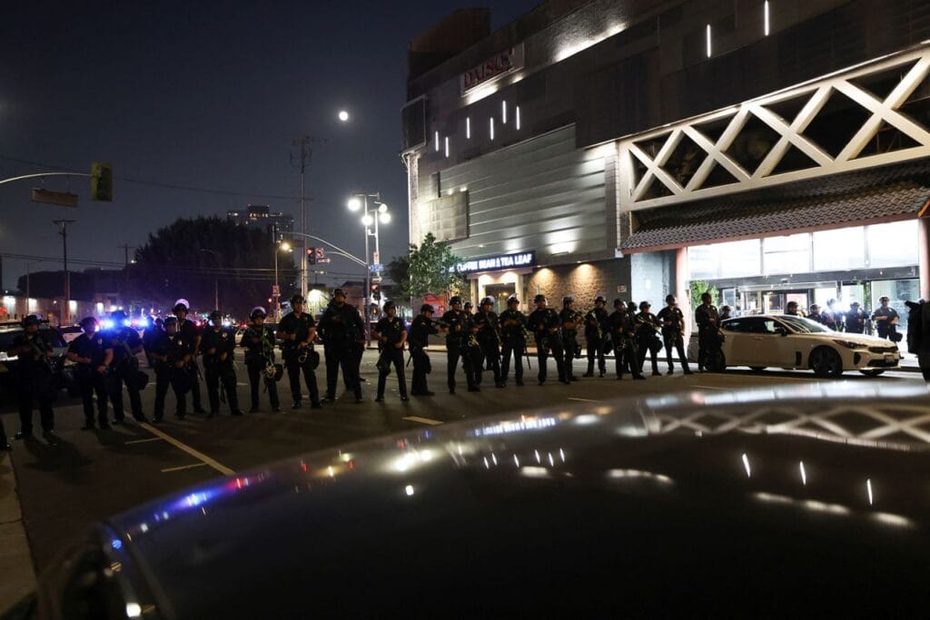 Law enforcement officers stand guard during a protest against federal immigration in downtown Los Angeles, California, on Monday. Aude Guerrucci/Reuters Law enforcement officers stand guard during a protest against federal immigration in downtown Los Angeles, California, on Monday. Aude Guerrucci/Reuters